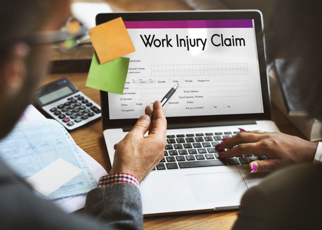 Person filling up a work injury claim
