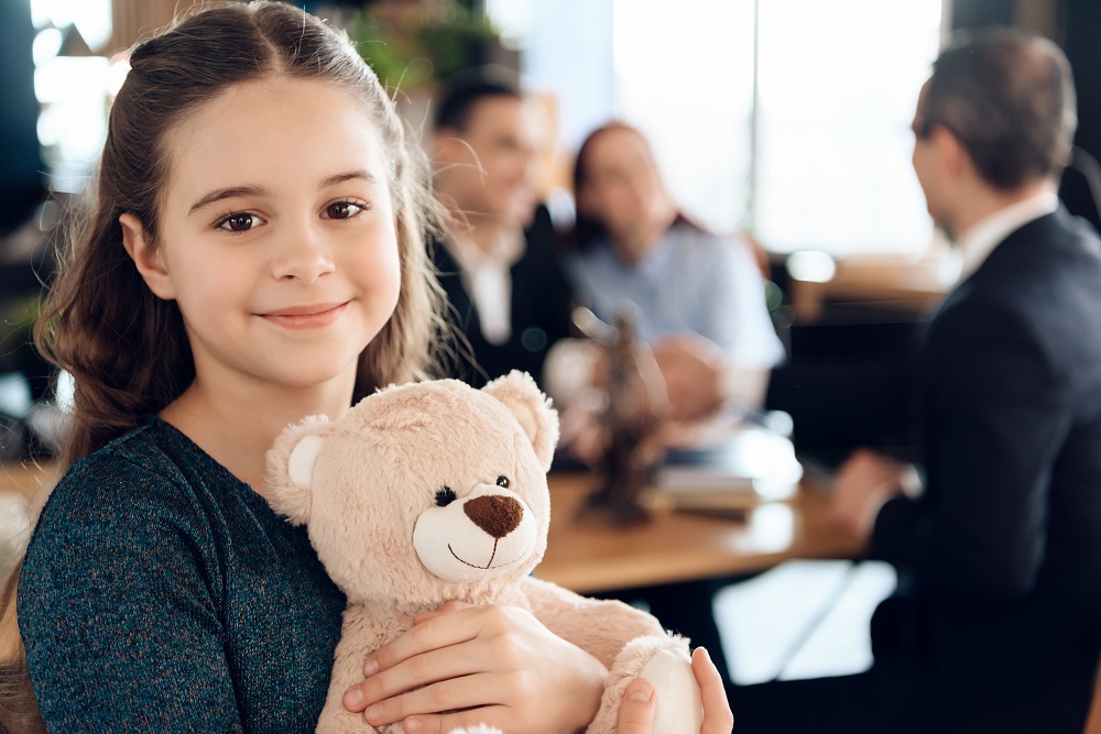 a girl holding her teddy bear
