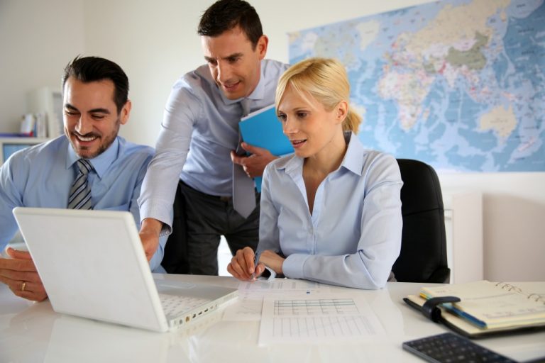 coworkers planning and managing with the use of laptop