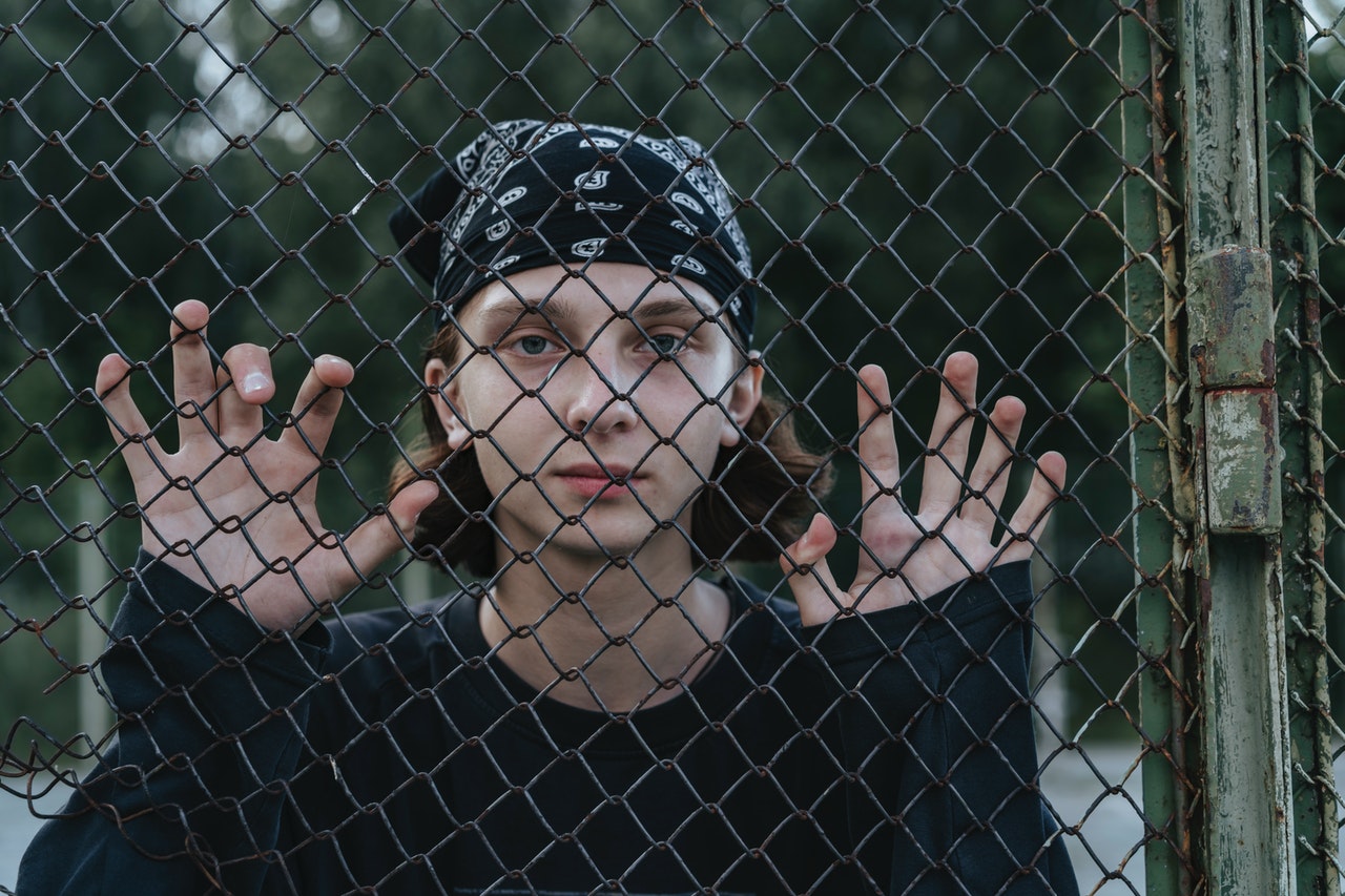 person looking outside a fence