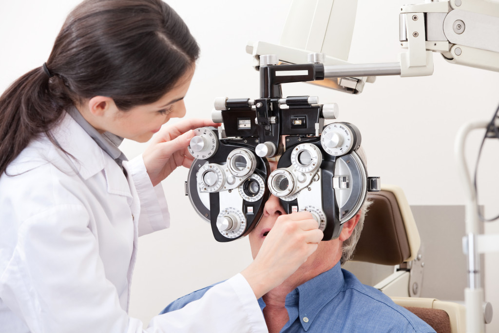 ophthalmologist checking patients eye with an instrument