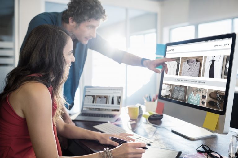 man and woman using a computer