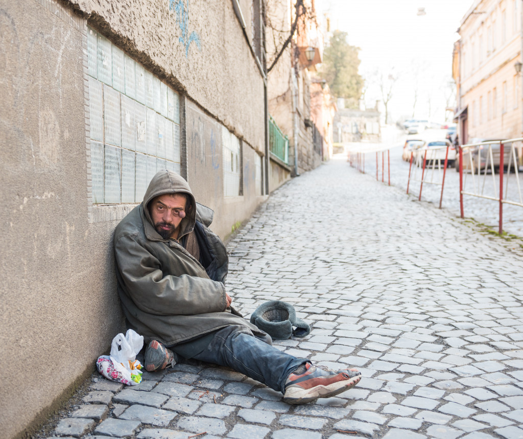 Homeless man sitting alone on the street