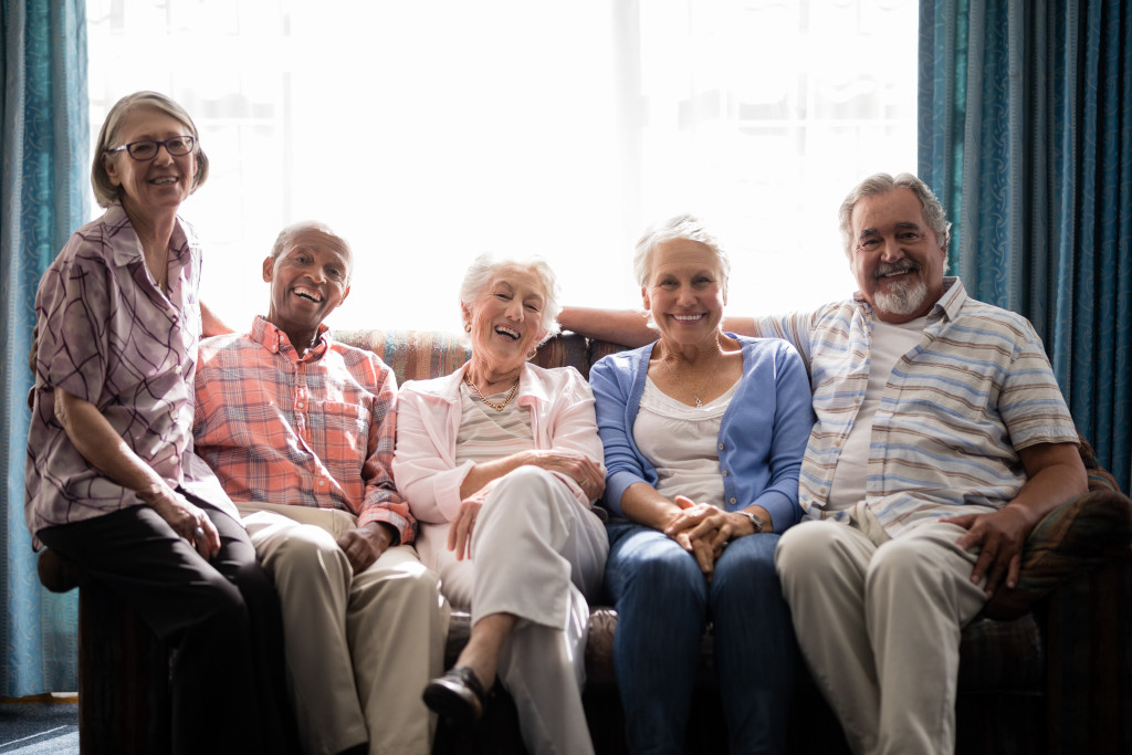 A groups of senior citizens sitting on a couch
