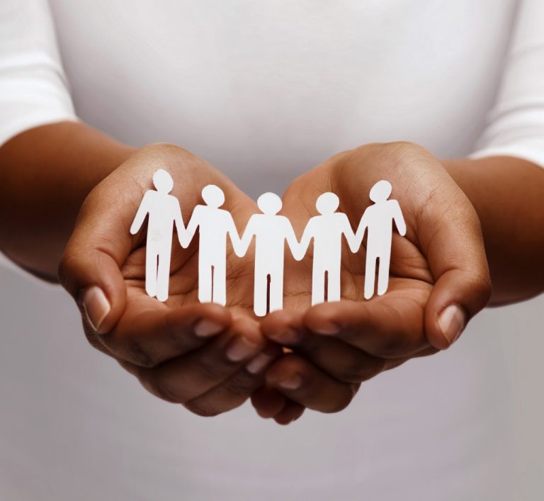 a woman holding paper cutouts of people